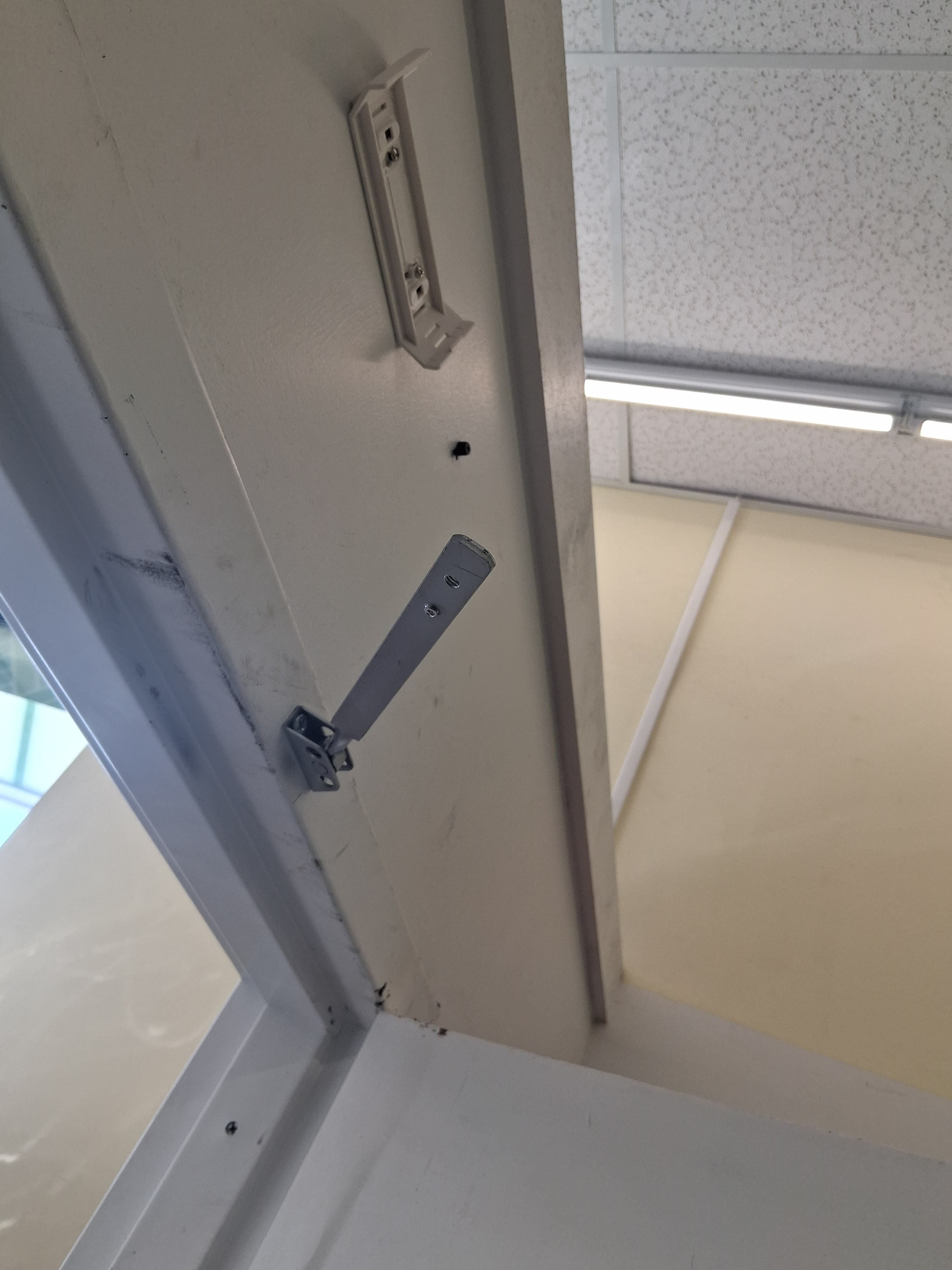 Commercial door closer before replacement